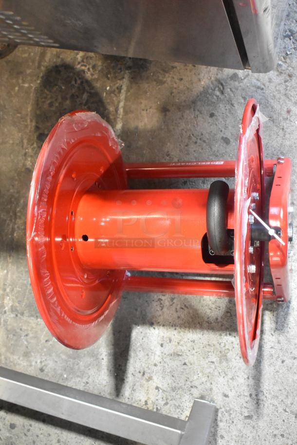 Reelcraft CA32112 L red metal hose reel, new condition, sturdy construction, visible branding on side.