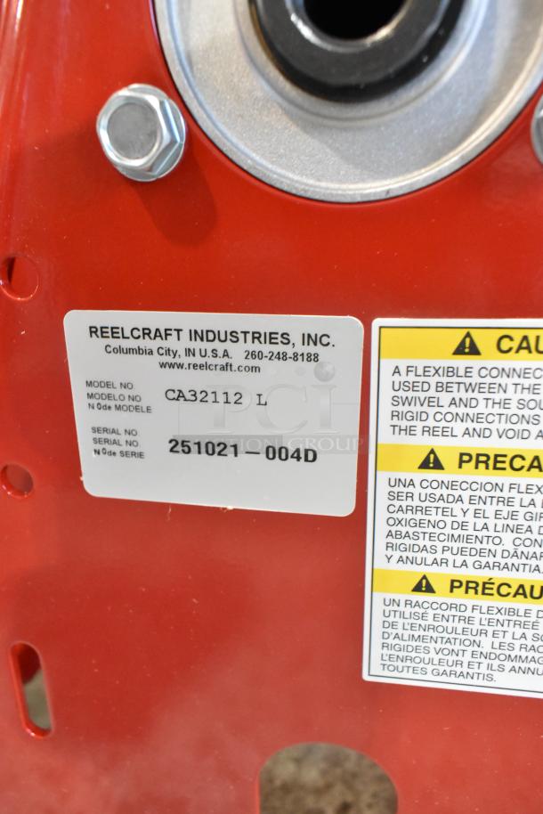 Reelcraft CA32112 L red metal hose reel with serial number 251021–004D. Model label visible for authenticity.