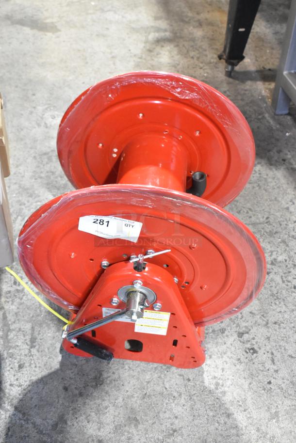 Reelcraft CA32112 L red metal hose reel, new condition, with handle and mounting bracket. Label with auction info visible.