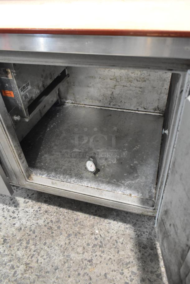 Randell 8268N stainless steel pizza prep table with 2 drawers, 1 door, commercial casters. Interior shows wear. 115V, 1 phase.