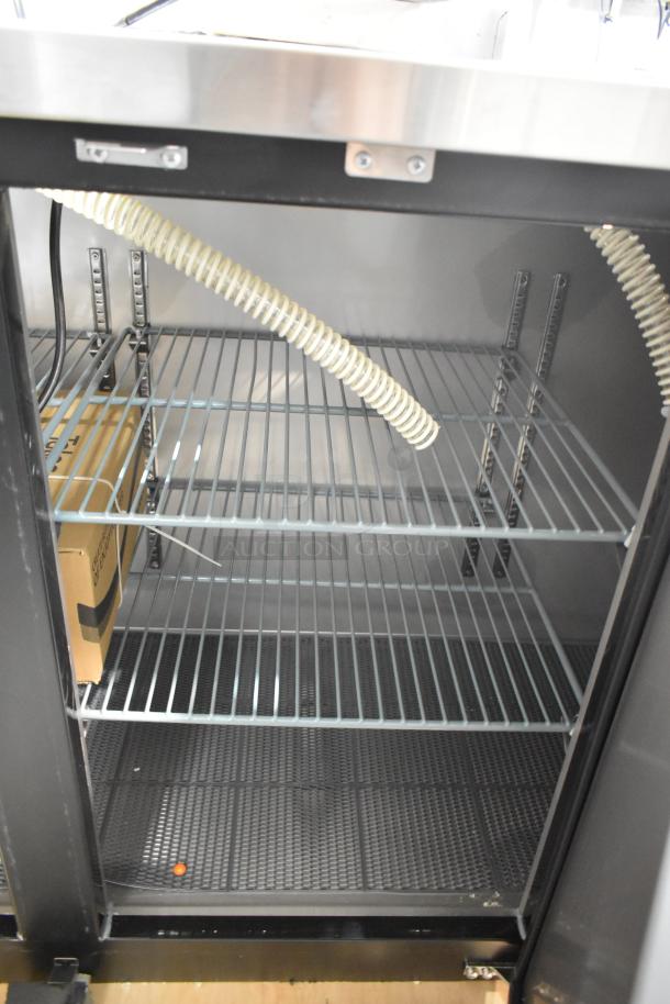 Brand new Avantco 178UDD72HC kegerator interior; black metal, three 1/2 keg capacity, 115V, slight scratches visible.