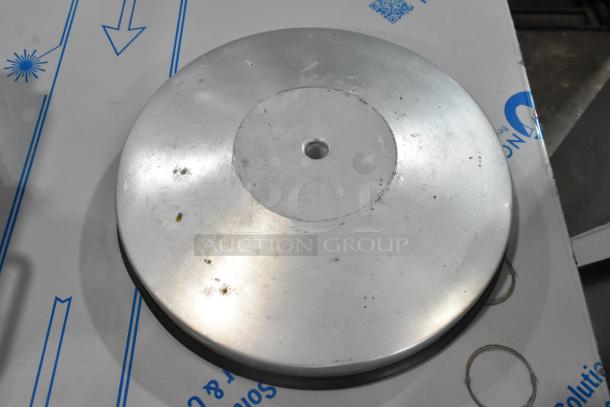 Chrome finish stanchion base, scratch and dent condition, round metal with a central hole, slight surface marks visible.