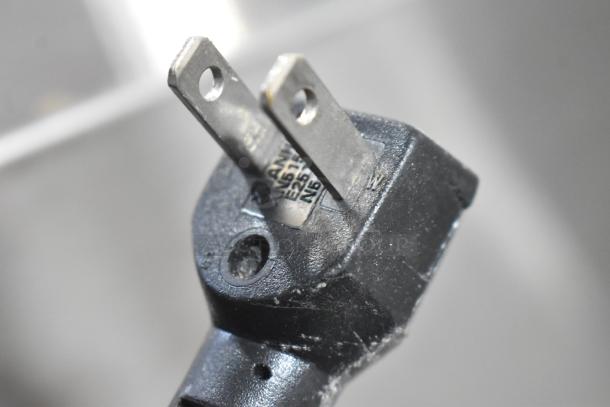 Close-up of a black, two-prong plug for the Everest Stainless Steel Commercial Prep Table, indicating 115 volts, 1 Phase.