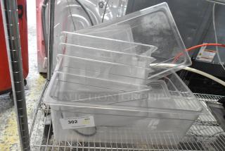Lot of 6 clear poly bins stacked on a metal shelf, used condition. Label reads "302 QTY VXL PCIauctions.com."
