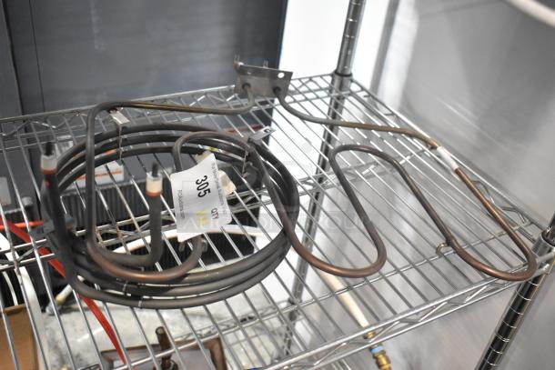 Two metal burners on a wire shelf, with attached wiring. Tag showing "Lot 305." Good condition, ideal for industrial use.