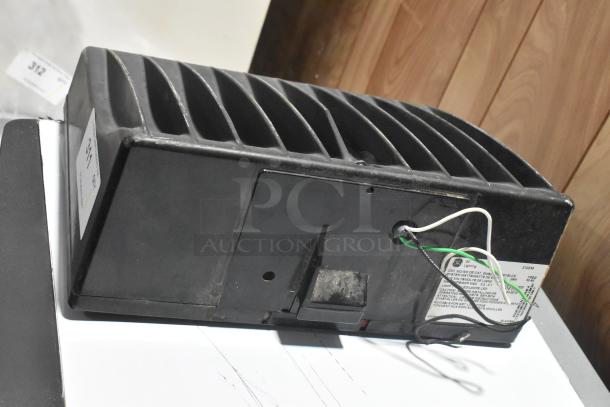 General Electric GE WMRETRO3-088 light, black, shows wires and labels, condition appears used, suitable for parts or repair.