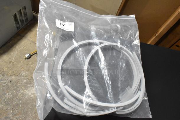 Clear plastic bag containing a white seal strip, in new condition. Label reads "Qty 312" from PCIauctions.com.