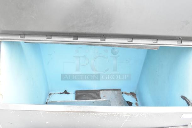 Manitowoc QY1305 stainless steel commercial ice head on bin, 208-230V, 1 Phase, visible interior with some wear.