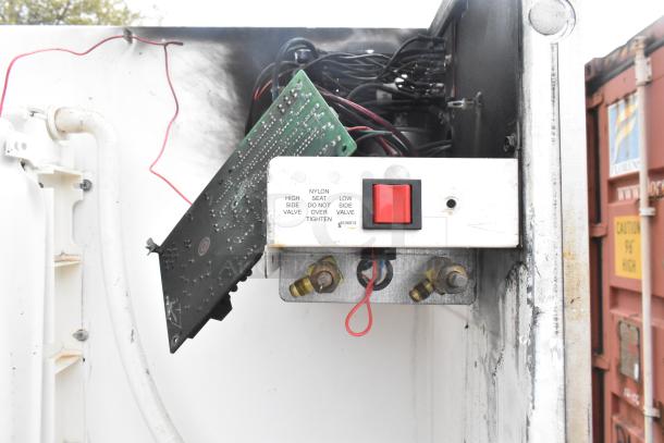 Manitowoc QY1305 ice maker's internal circuitry, showing control panel with red switch and wiring, 208-230V, 1 phase.