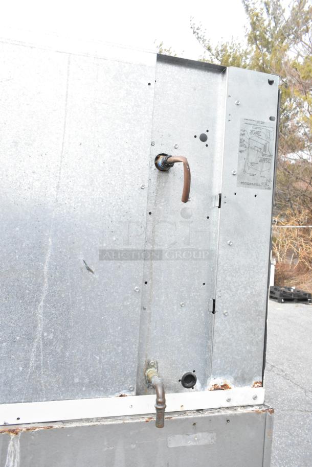 Manitowoc QY1305 stainless steel commercial ice head on ice bin, 208-230V, 1 phase, visible rust, instructions label.