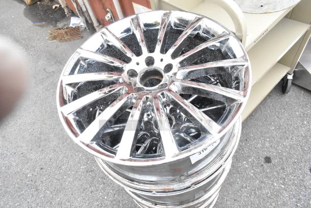 4 metal rims with a shiny chrome finish, 10-spoke design, showing slight wear. Stack of rims with visible numeric label.