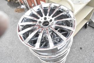 4 metal rims with a shiny chrome finish, 10-spoke design, showing slight wear. Stack of rims with visible numeric label.