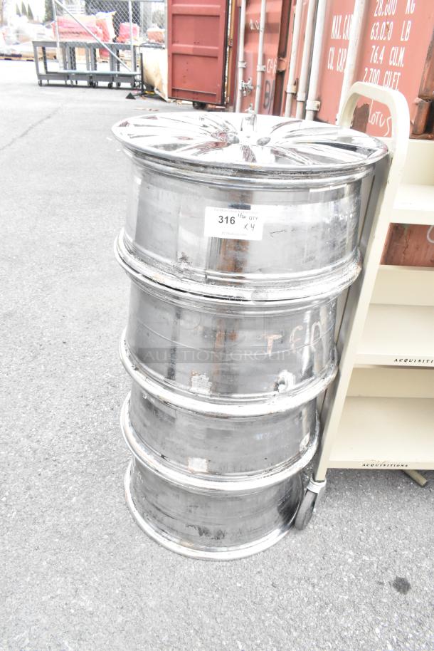 Four stacked metal rims, slightly worn, with label "316 QTY x 4" indicating set quantity. Auction item.
