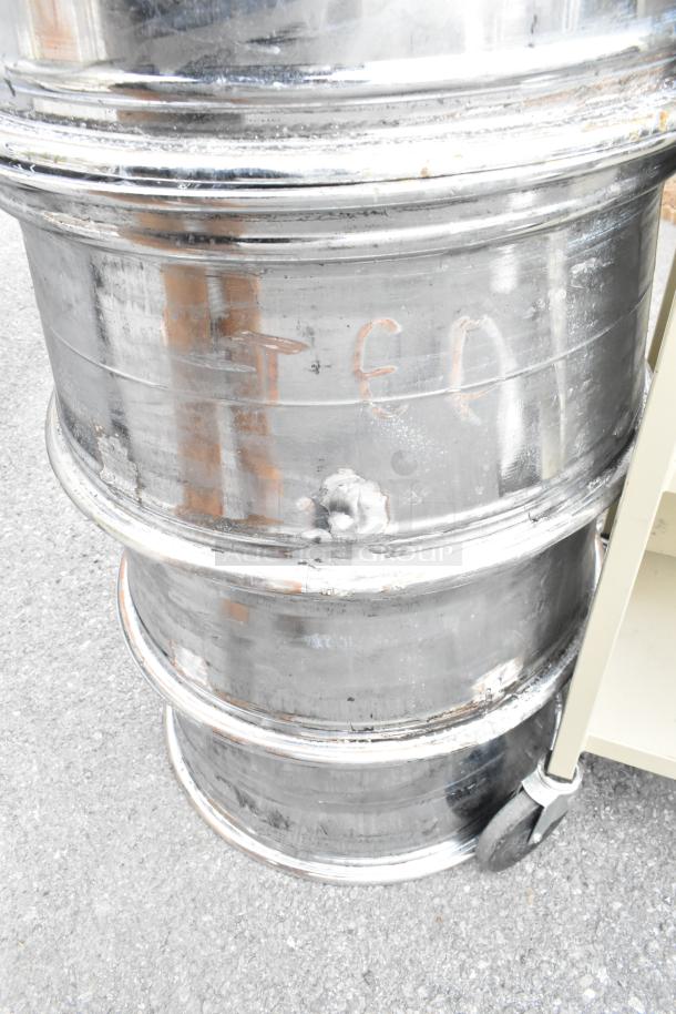 Four stacked metal rims with visible wear and markings, indicating use. Marks read "TEN." Sold as 4x lot in auction.