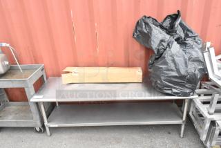 Stainless steel equipment stand with metal under shelf, sturdy condition, featuring top work surface, ideal for industrial use.