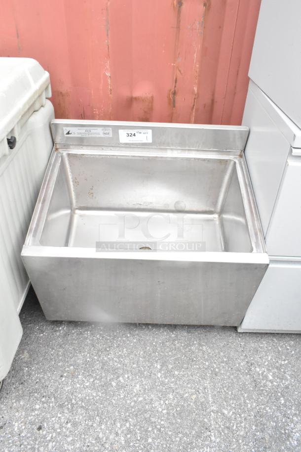 Stainless steel commercial ice bin without legs, features drain hole, visible sticker indicating model KCS, minor surface wear.