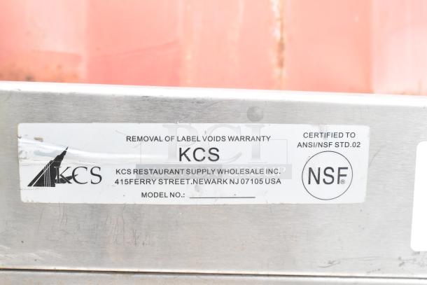 Stainless steel commercial ice bin, no legs, KCS brand. Label: removal voids warranty, ANSI/NSF certified, Newark, NJ.