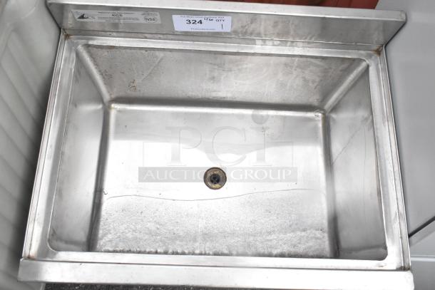 Stainless steel commercial ice bin, top view, no legs, visible wear. Labels show NSF certification and auction lot number 324.
