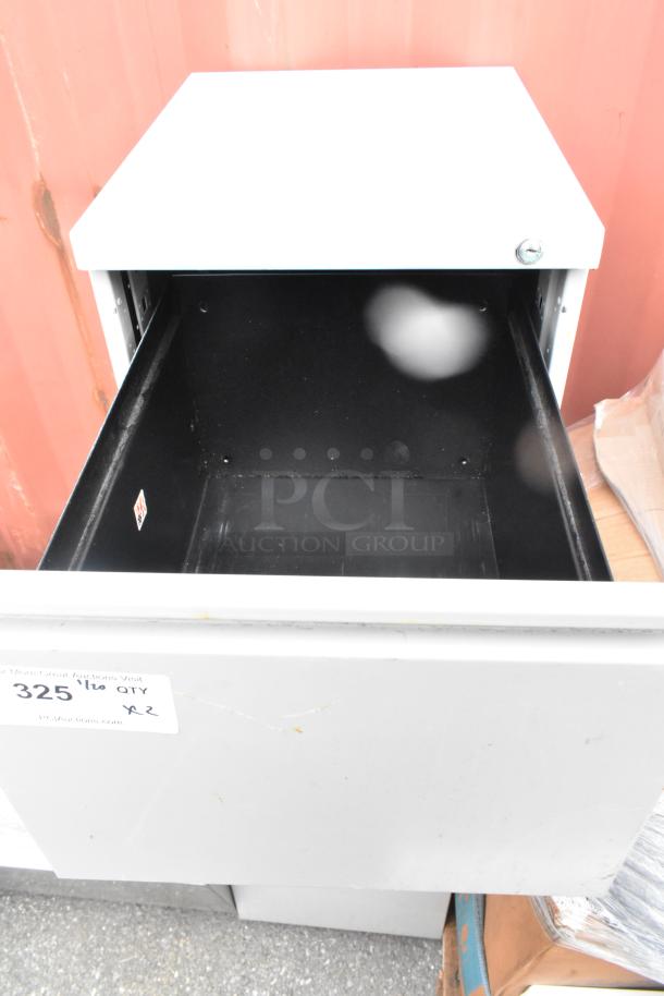 Two gray metal two-drawer filing cabinets, open drawer, slight wear, auction label "325 1/2 QTY x2".