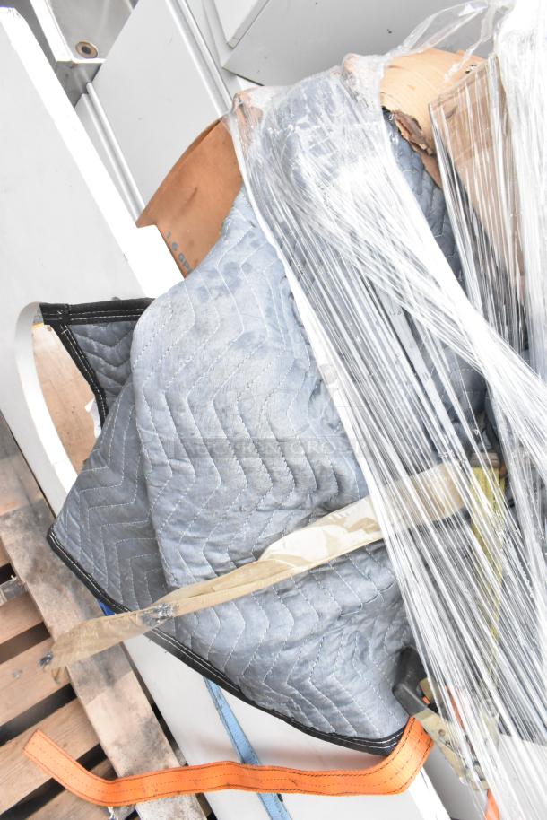 Pallet of assorted items wrapped in plastic, featuring AO Smith 12-gallon water heater and Dorian MS914114 tank, with packing blanket.