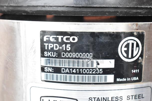 Label on Fetco TPD-15 Luxus Beverage Dispenser, SKU: D00900000, SN: DA1411002235, stainless steel, made in USA.