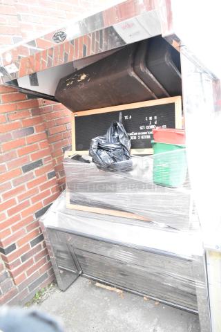 Marc Metal Commercial Open Grab N Go Merchandiser, wrapped, with assorted contents. Metal exterior shows visible wear.