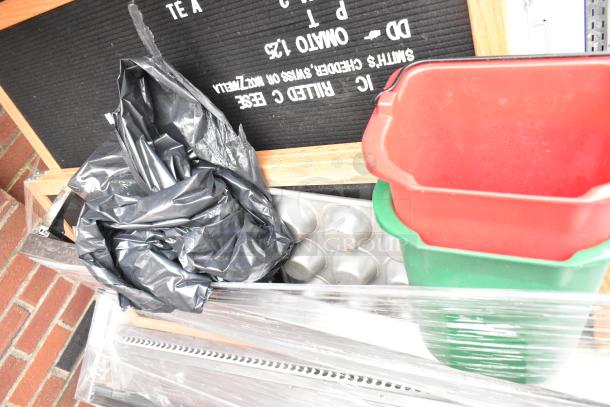 Marc Metal Grab N Go Merchandiser with contents, including a black garbage bag, red and green bins, and a baking tray.