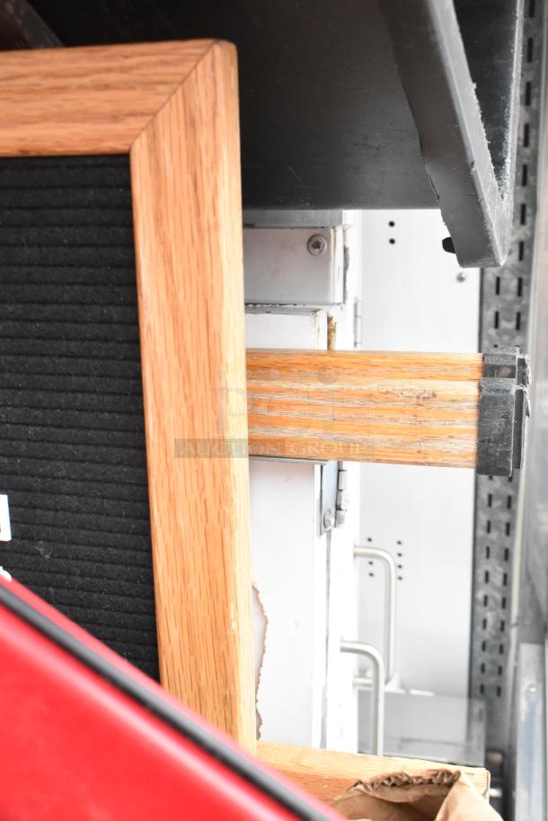 Marc Metal Commercial Floor Merchandiser with oak trim and metal components. Includes visible contents and signage. Good condition.