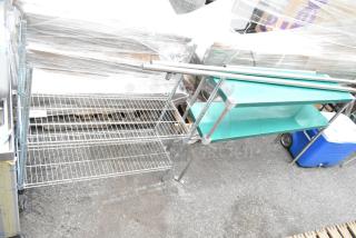 Two-tier chrome wire shelving unit and green metal two-tier shelving unit, both in good condition.