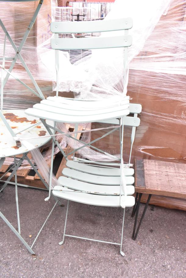 6 metal items include 2 folding chairs, 2 folding tables with some rust, and 2 wooden benches; mixed condition.