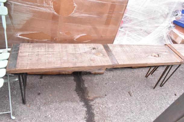 Wooden bench with metal legs, rustic finish. Part of auction lot including 2 benches, 2 tables, and 2 chairs.