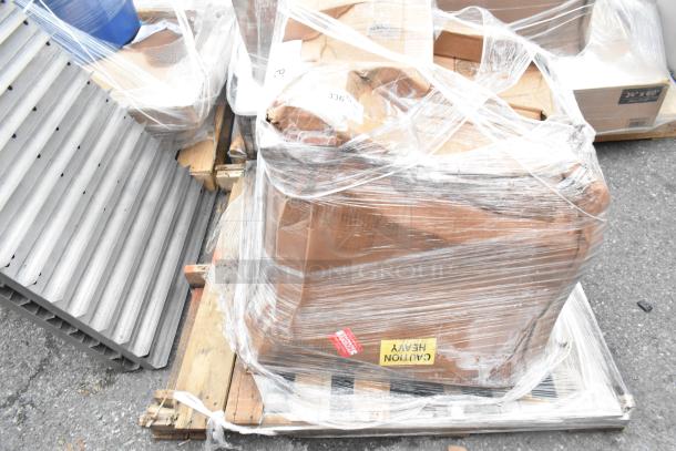 Brand new Regency 29" stainless steel sink with visible scratches, wrapped on a pallet marked "Caution Heavy".