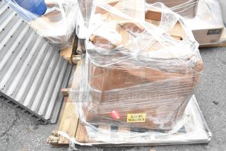 Brand new Regency 29" stainless steel sink with visible scratches, wrapped on a pallet marked "Caution Heavy".