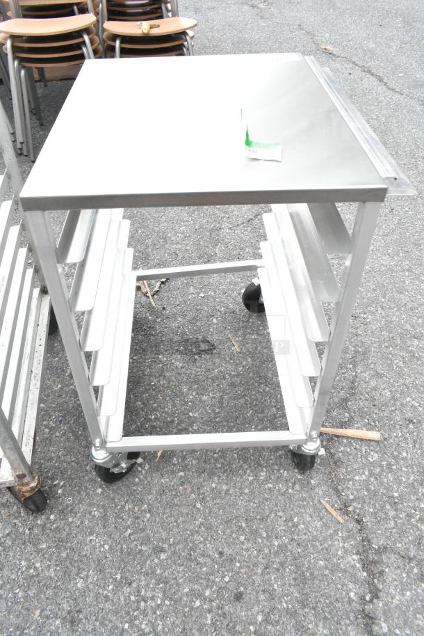 Regency 600upr6wtels 6 pan aluminum undercounter bun rack with stainless steel top, holds sheet pans, wheels, side channel.