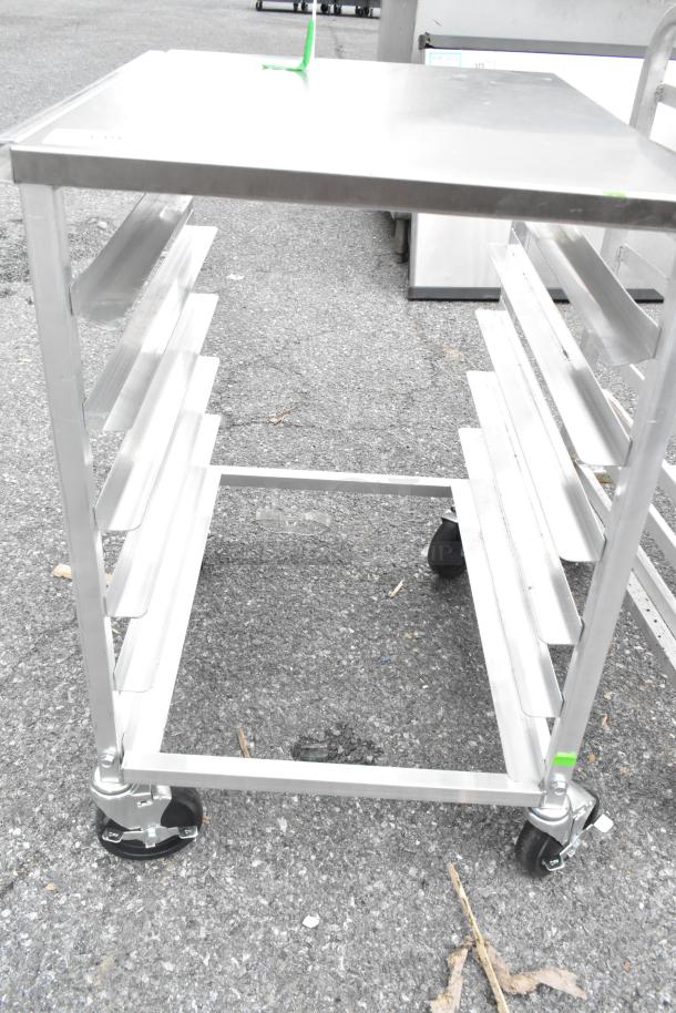 Regency 600upr6wtels aluminum undercounter pan rack, stainless steel top, end load design, six-pan capacity, on casters.