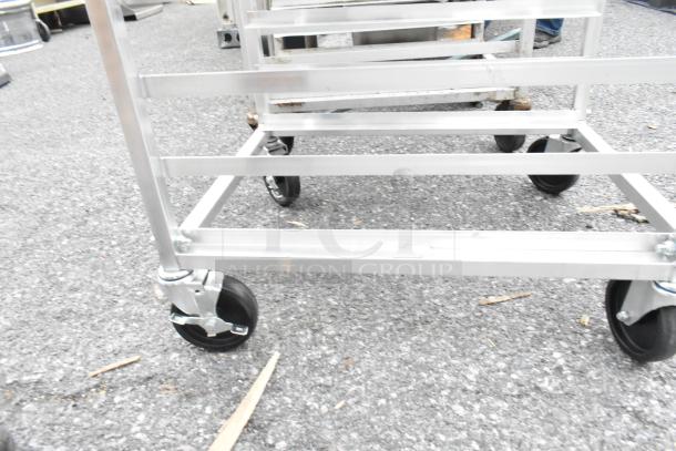 Regency 600upr6wtels aluminum undercounter pan rack, 6-pan capacity, stainless steel top, side channel, on casters.