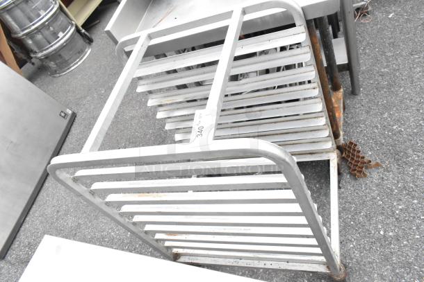 Metal bun/sheet pan rack on commercial casters, visible wear and rust, labeled "340".