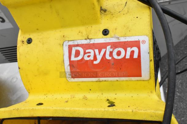 Stainless steel table with metal under shelf and backsplash, includes two Dayton air mover fans. Dayton logo visible on fan.