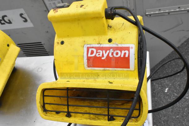 Stainless steel table with metal under shelf, back splash, and two Dayton air mover fans. Used condition.