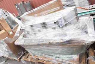 3 brand new scratch and dent items on a pallet, including Regency drain, legs, and sink. Plastic-wrapped for protection.