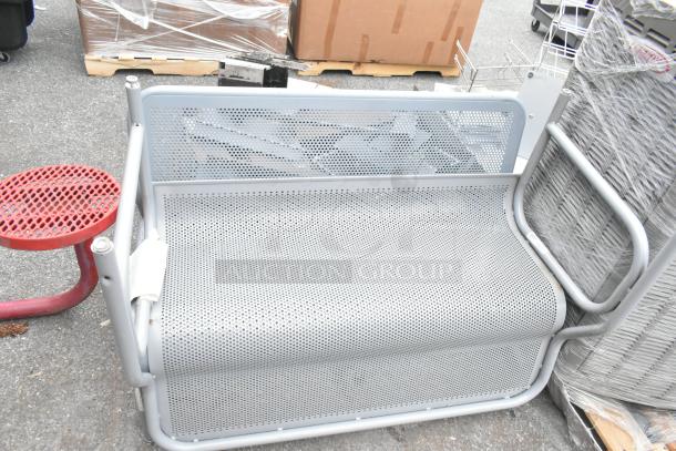 Red mesh table and two gray mesh benches; metal construction, modern design, good condition for indoor/outdoor use.