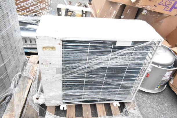 Emerson XFAM-037X-TFC-081 metal split type air conditioner, 208-230V, 3 phase, wrapped for storage, on a wooden pallet.