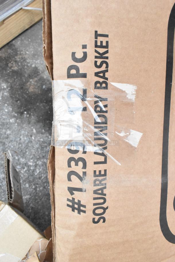 Cardboard box labeled "#1239 12 PC. Square Laundry Basket", showing light wear with tape visible.