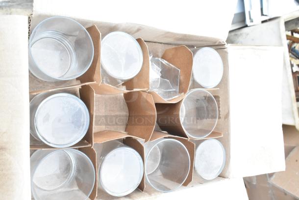 Box containing 8 new glass items with visible scratches. Items include salad bowls. Cardboard dividers present.