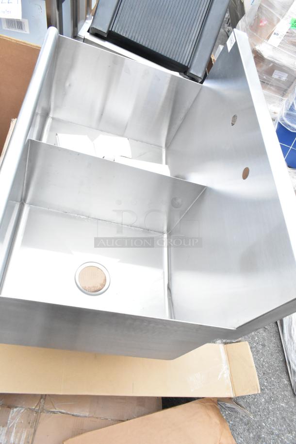 Brand new industrial stainless steel sink, scratch and dent condition, dual compartment with drain holes, on pallet.