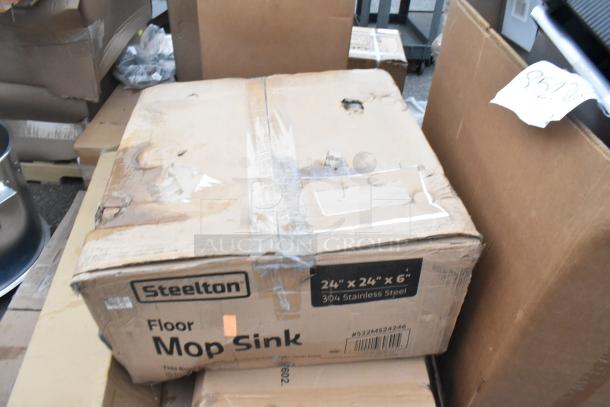Box labeled "Steelton Floor Mop Sink," 24"x24"x6", 304 stainless steel, showing signs of wear and tear.
