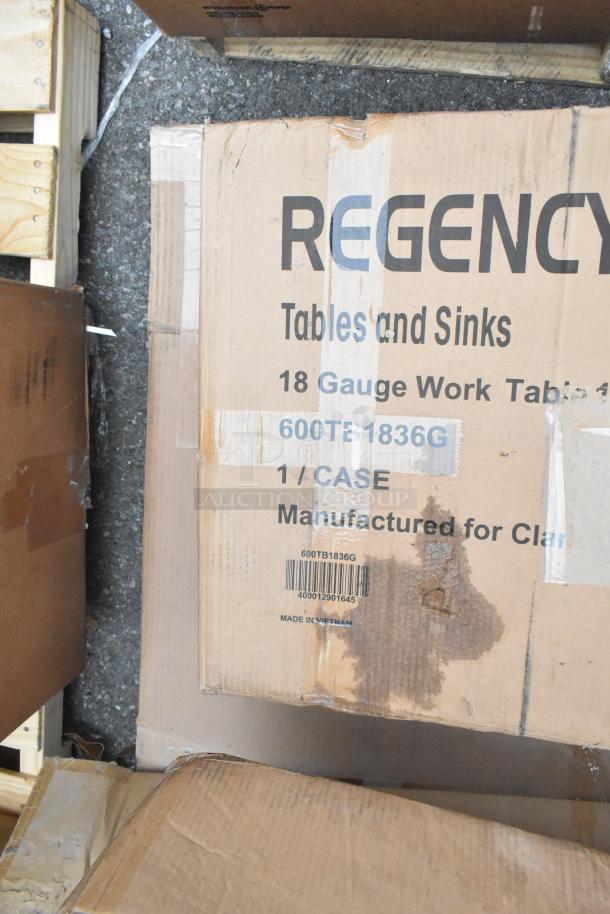 Cardboard box labeled "Regency 18 Gauge Work Table," visible wear and tear, item code 600TB1836G, made in Vietnam.