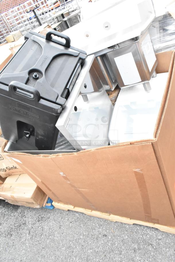 Cardboard box containing five brand new scratch and dent items, including sinks and an ingredient bin. Labels indicate "Dump Sink."
