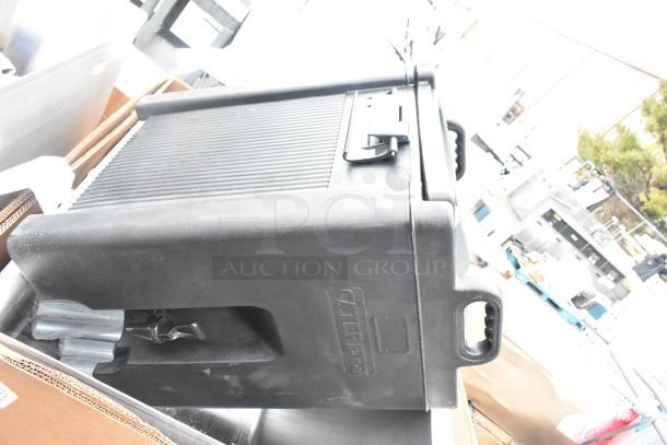 Black Cater cart in good condition, with visible latch, handle, and logo. Part of 5 brand new scratch and dent items.