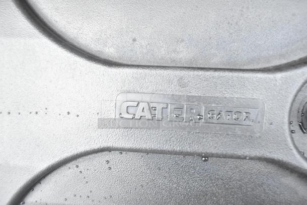 Close-up of a CaterGator item with water droplets on gray textured surface, indicating brand label. Part of a scratch and dent auction set.